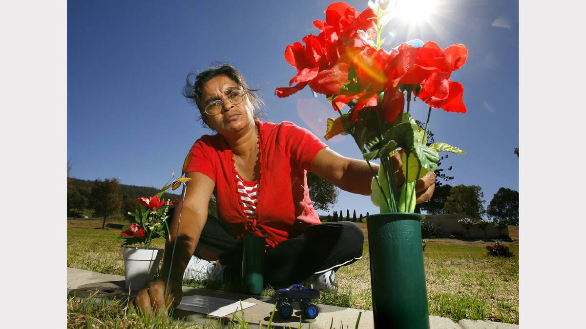 2009 - Donna Thomas puts flowers on her son's grave