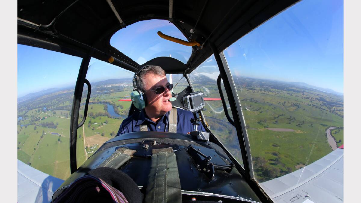 Pilot Stephen Death at the controls of a De Havilland Chipmunk aeroplane over Albury and Lake Hume. Picture: MATTHEW SMITHWICK