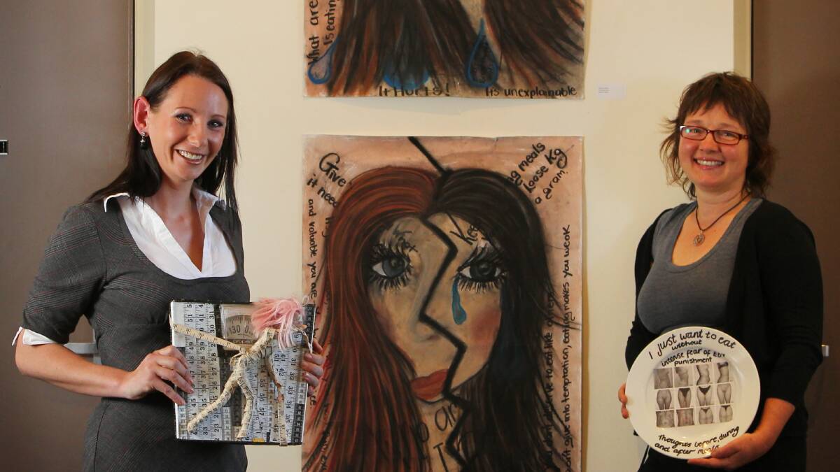 Eating Disorder Awareness Group member Sherylin Jones and facilitator Kim Haebich are hoping to eliminate the stigma that comes with an eating disorder through the art works of people affected. Picture: MATTHEW SMITHWICK