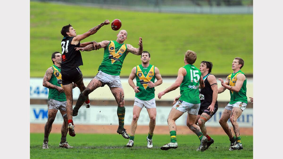 Lavington's Tom Yensch fists the ball away in front of North Albury's Ben Ryan.