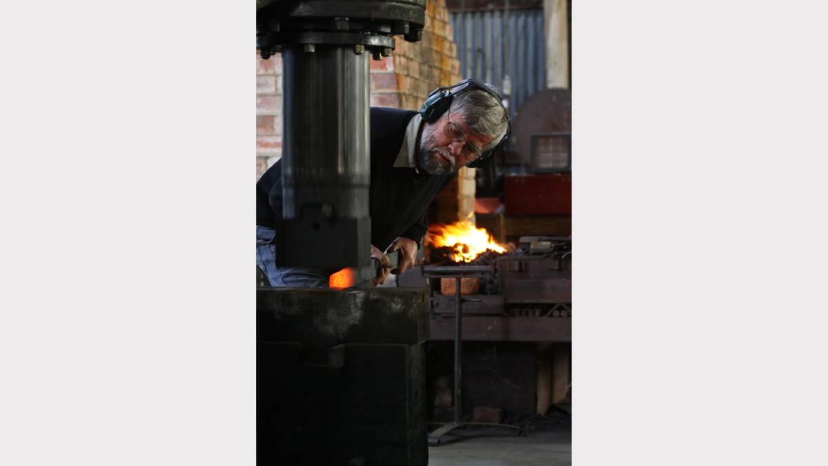 12. Blacksmith Max Bowran shapes the end of a piece of metal. Picture: BEN EYLES