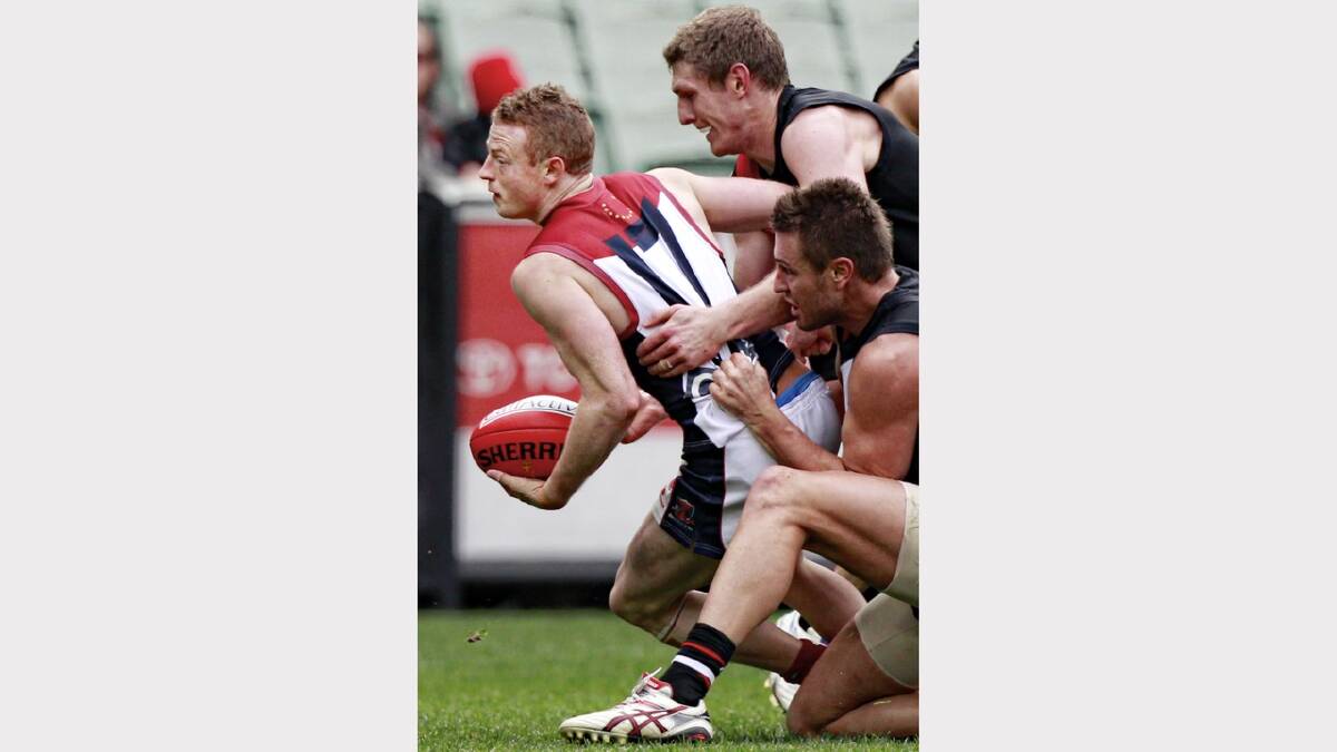 Demons forward Sam Blease is gang-tackled by Saints Ben McEvoy. Picture: FAIRFAX