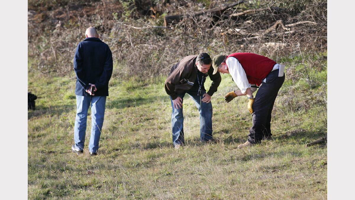 2007 -  .Detectives look at a bone found near a T-shirt in a week-long search for the missing body of Daniel Thomas. 