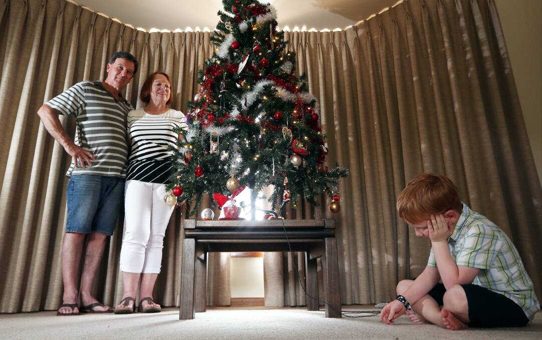 Glenn and Claire Roennfeldt with thier grandson Edward O'Connor, 5, were heartbroked to wake up this morning to find some someone had broken into their house and stolen all of the presents from under the tree. Picture: JOHN RUSSELL