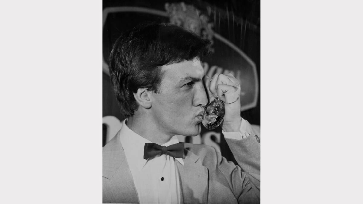 Mike Eden kissing the Rothmans medal he won while playing for Eastern Suburbs in 1983.