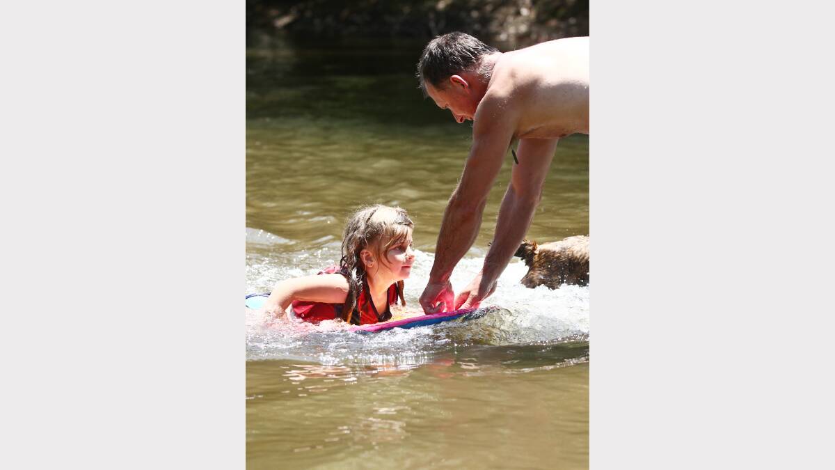 Wayne Anderson tows Alicia Turner, 5, through the water. 