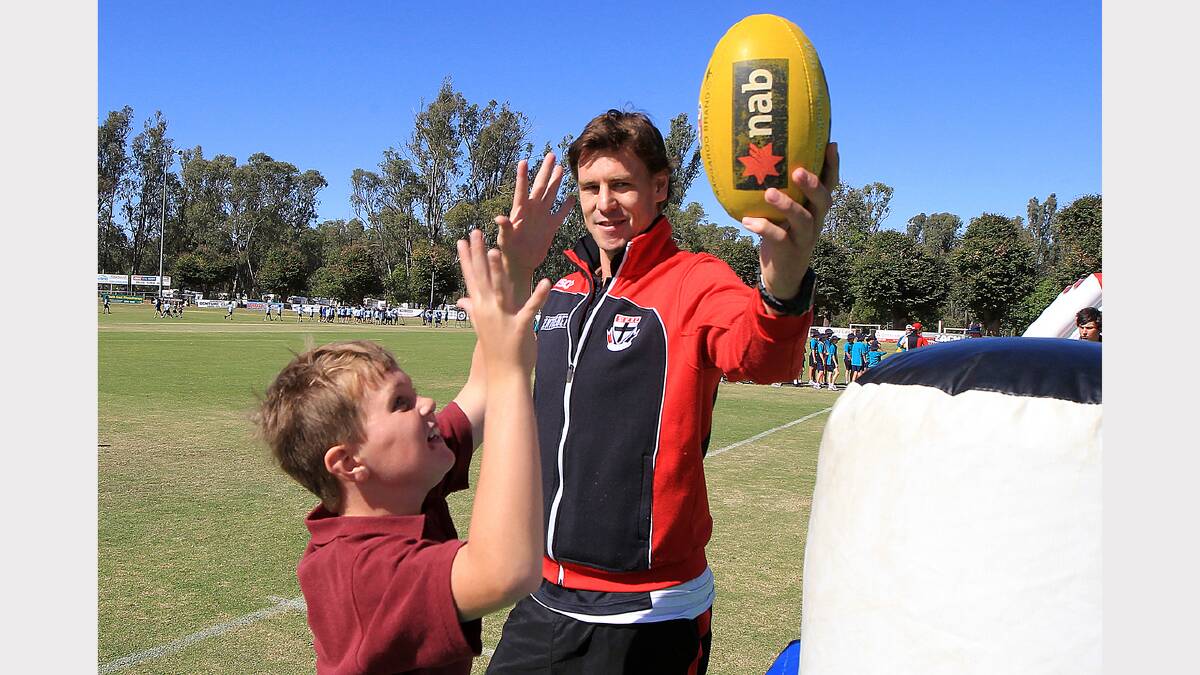 Ethan Stephens, 9, of Mulwala primary school jumps up to get the ball that Justin Koschitzke was holding during a clinic at J.C Lowe Oval. Picture: PETER MERKESTEYN