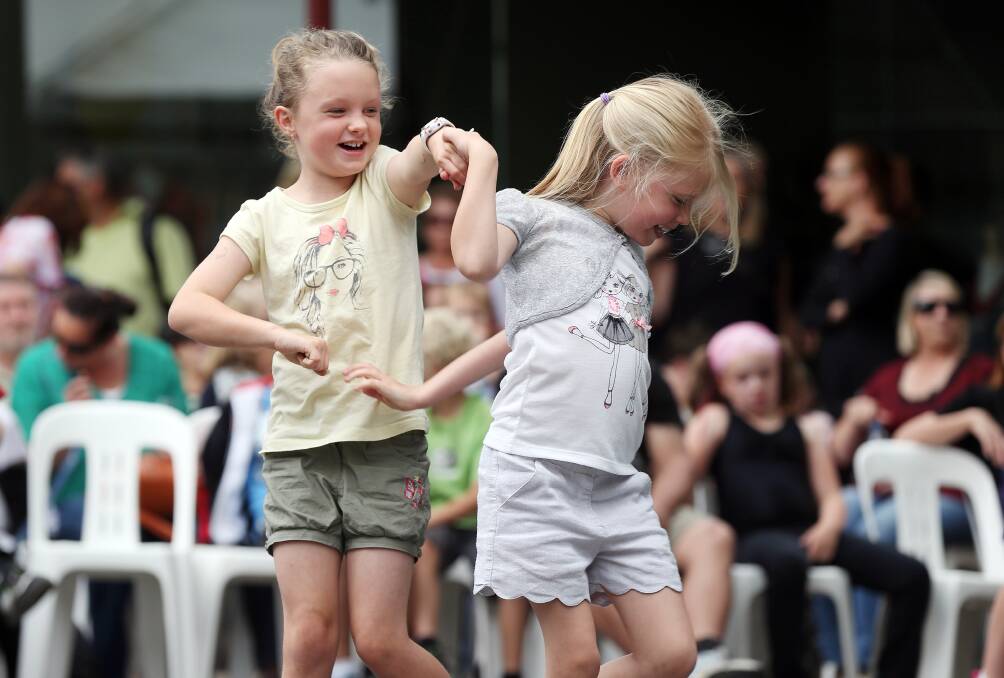 Ella Bradley, 8, and Mia Johnson, 6, dance at the Reid Street Community Stage. 
