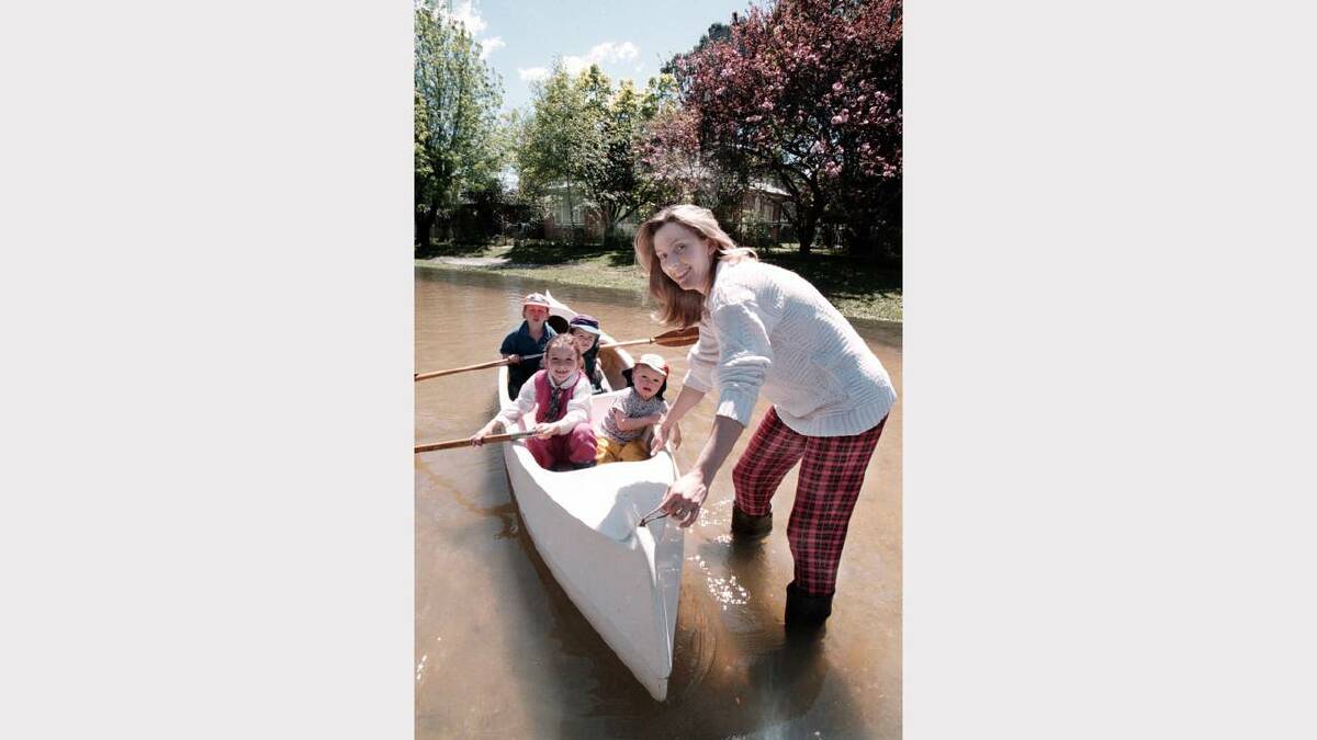 Cathy Peacock and children Sarah, 6; Tom, 18mths; Jack,7 and Ned, 3 could only get around by canoe after floods surrounded their home off the Lincoln Causeway.