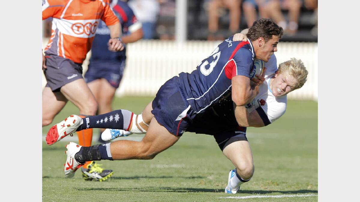 The Waratahs' Matt Lucas and Rebels' Tom English do battle at the Super Rugby trial. Picture: BEN EYLES