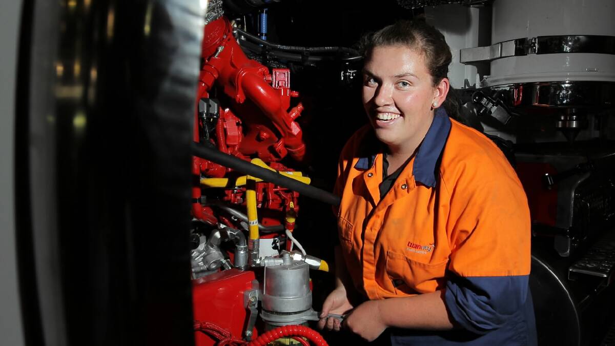 Ezra Lonergan, 18, deferred her university offer to take on a diesel mechanic apprenticeship. She is pictured changing the primary fuel filter on a Kenworth 909 truck in january this year.