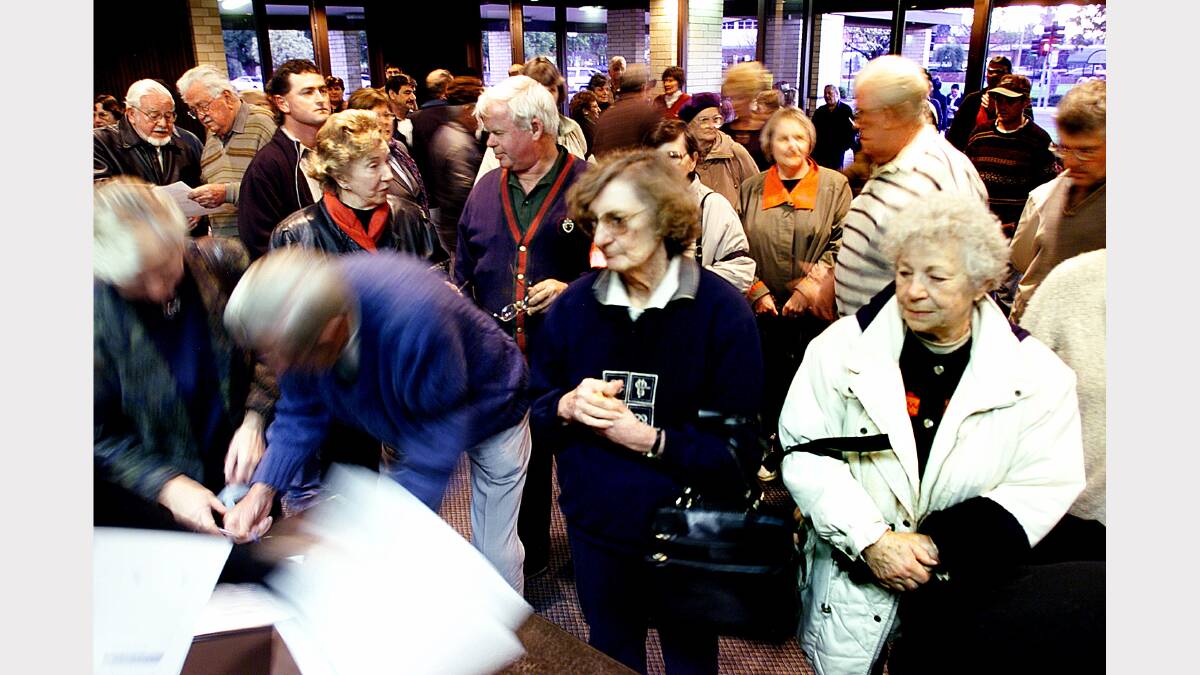Wodonga residents line up to sign the register of attendance at the One City forum. Picture: KATE GERAGHTY