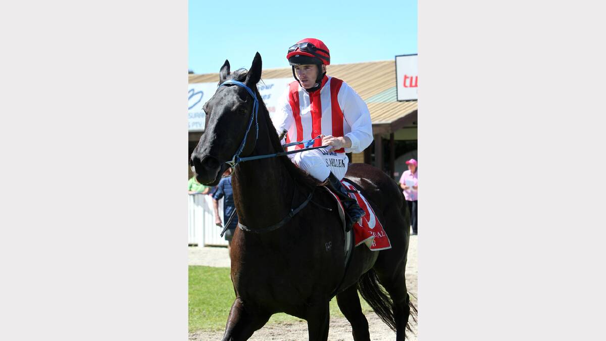 Jockey Simon Miller on winning horse 'Lateandknewit' 