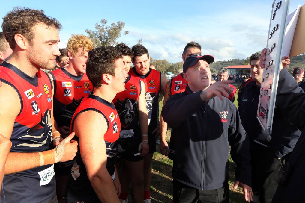 Raiders co-coach Ken Stevenson talking to his troops at half-time during a game. 