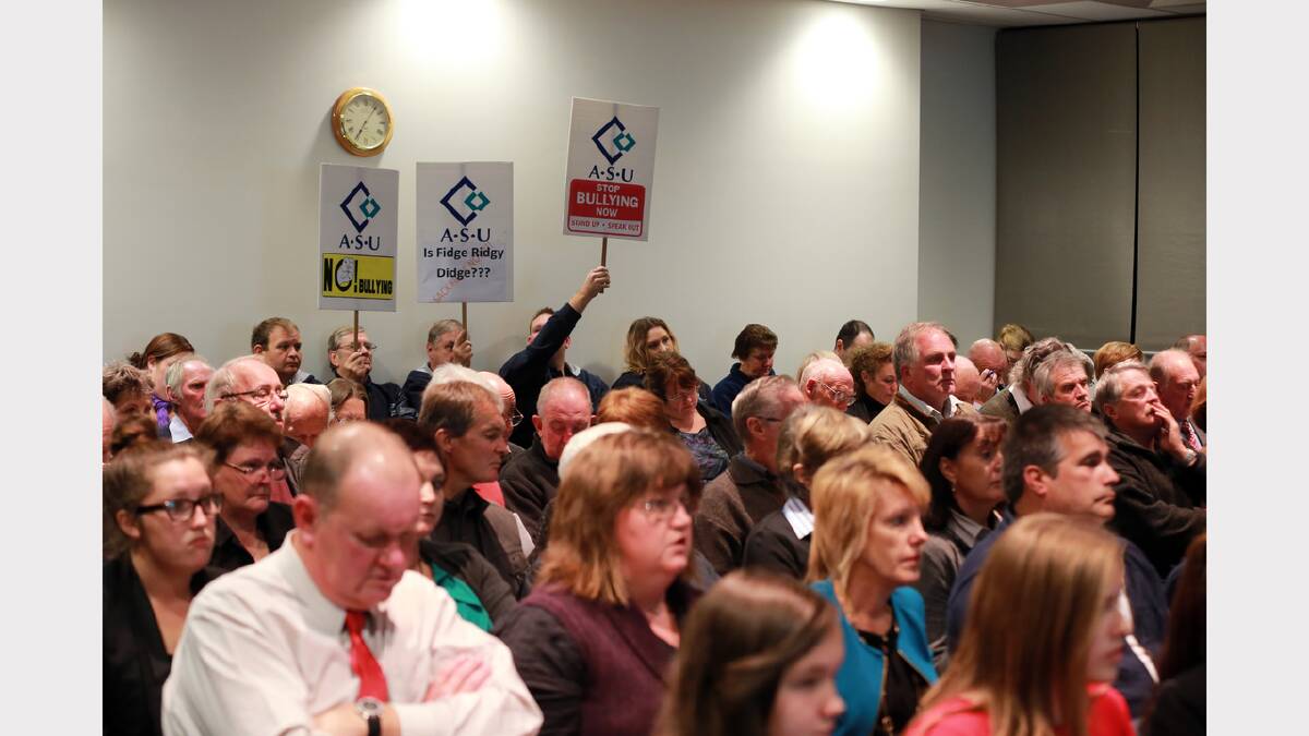 Protesters attend a council meeting. 