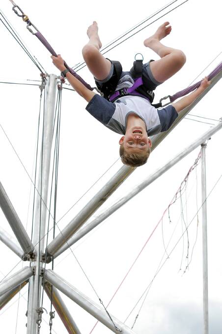 Tyler Spencer, 14, of Corowa, flipping upside down on the giant trampoline yesterday. 