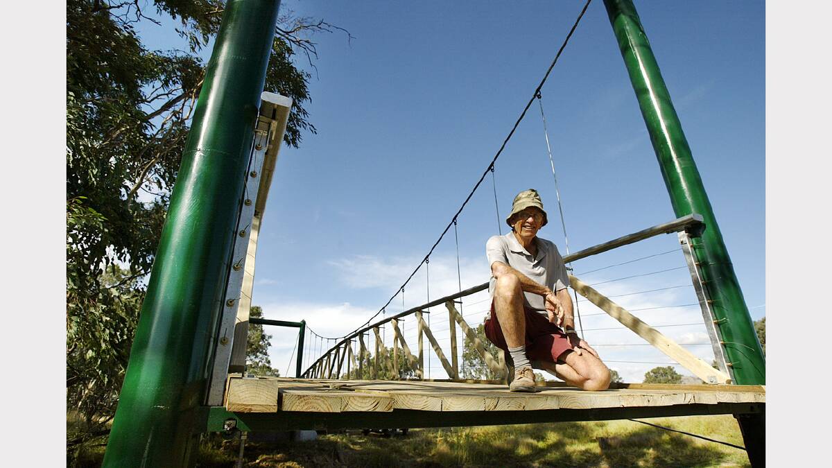  John Hillier stands on the soon to be completed Swing Bridge near the Kiewa river across an anabranch of Finn Creek. (2006)