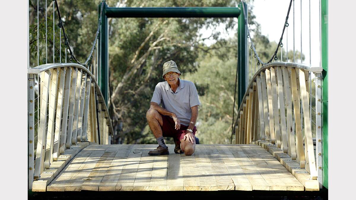  John Hillier stands on the soon to be completed Swing Bridge near the Kiewa river across an anabranch of Finn Creek. (2006)
