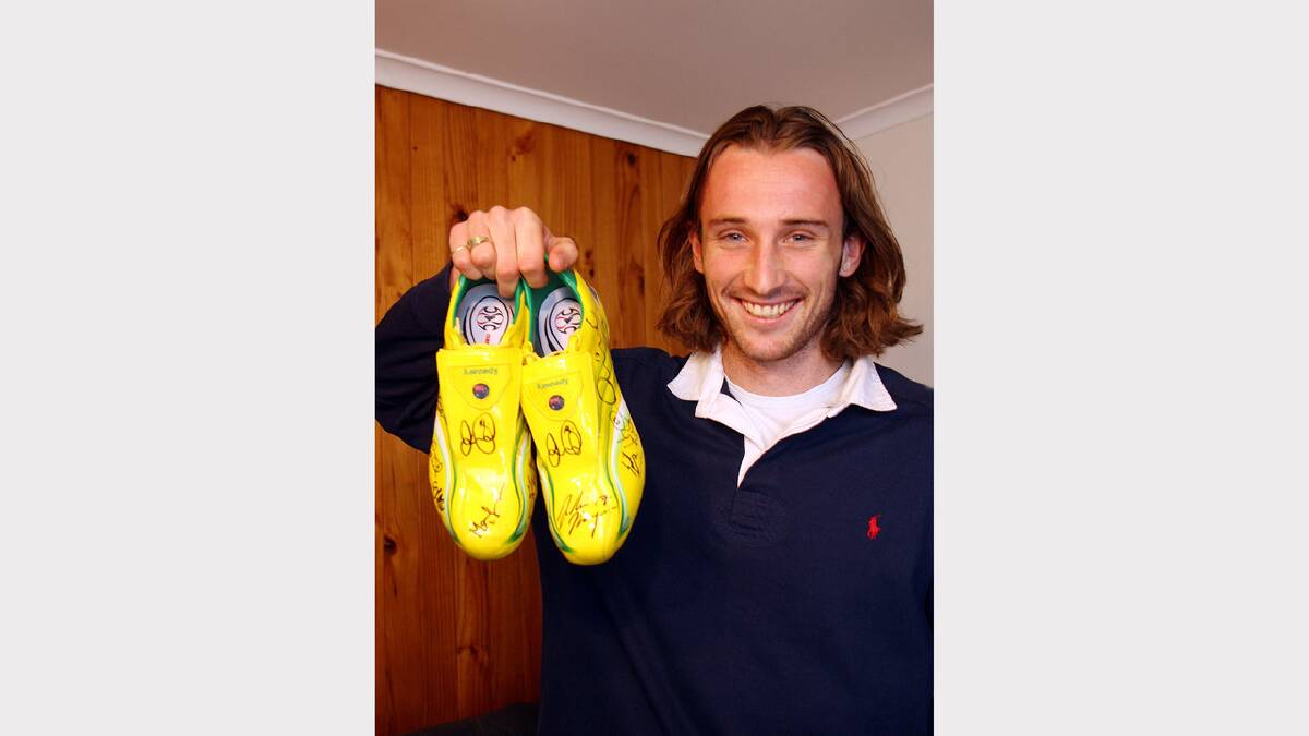 World Cup soccer star Josh Kennedy back home in Wodonga with his prized boots as a memento of the occasion. (2006)