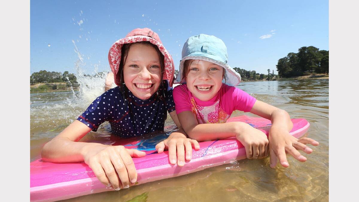 Sisters Annabele and Clare Martinae, aged 10 and 7, cool off at Beechworth. 