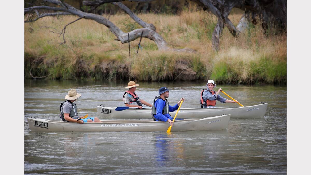 Four men enjoy time on the water in their hired canoes. 