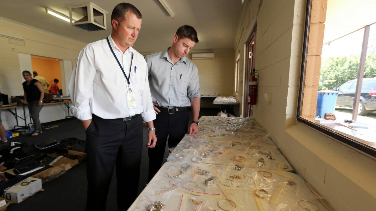 Detective Sen-Constable Matt Prestage, of Cobram CIU, and Sen-Constable Anthony Clifford, of Albury anti-theft unit, and some of the hundreds of items recovered after recent burglaries on both sides of the border. 
