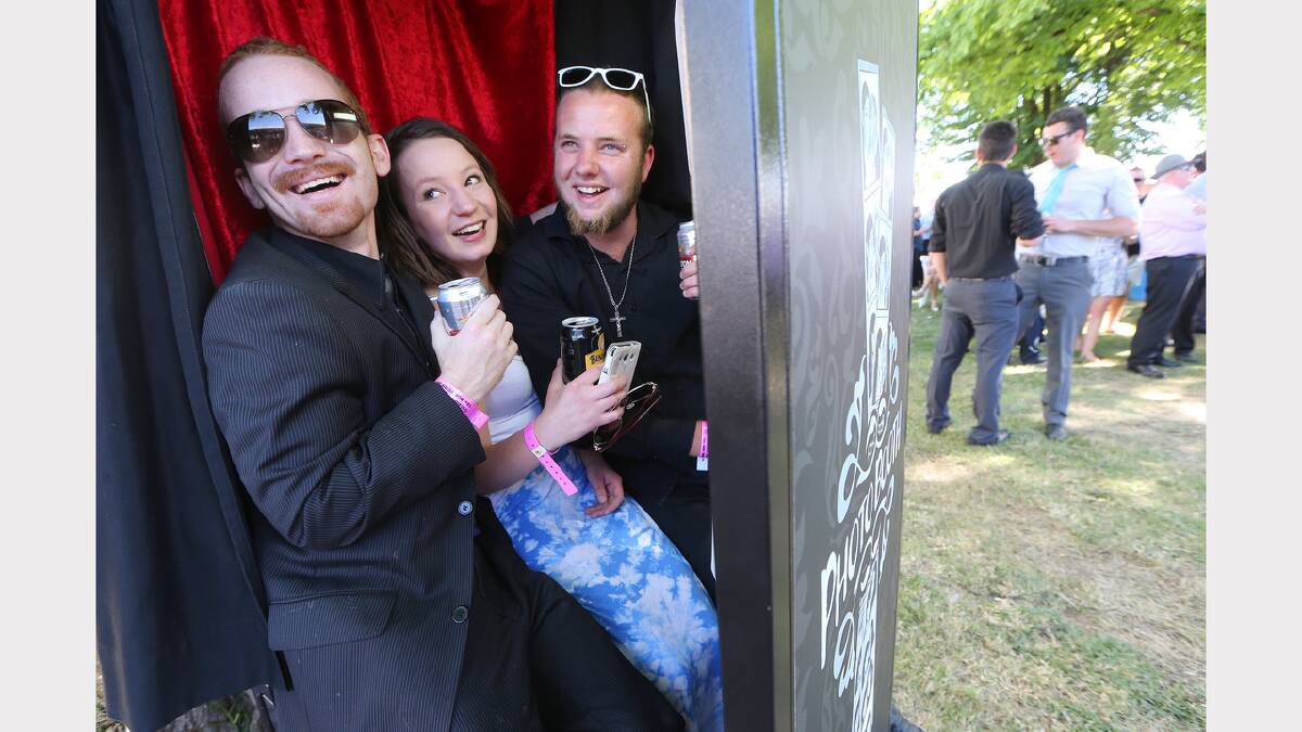 Zac Lewis-Driver, Jayde Coates and Brandon Gaffy of Wodonga check out the photo booth at the track.