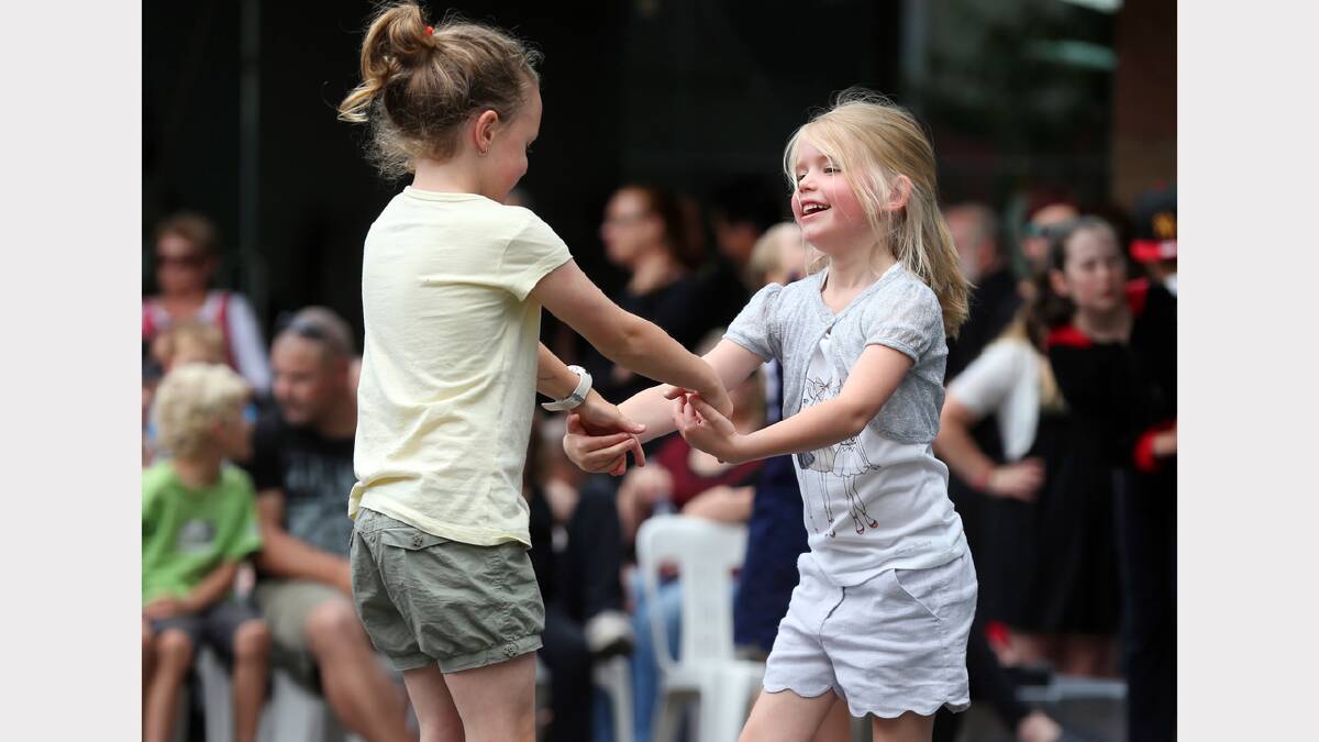 Ella Bradley, 8, and Mia Johnson, 6, dance at the Reid Street Community Stage.