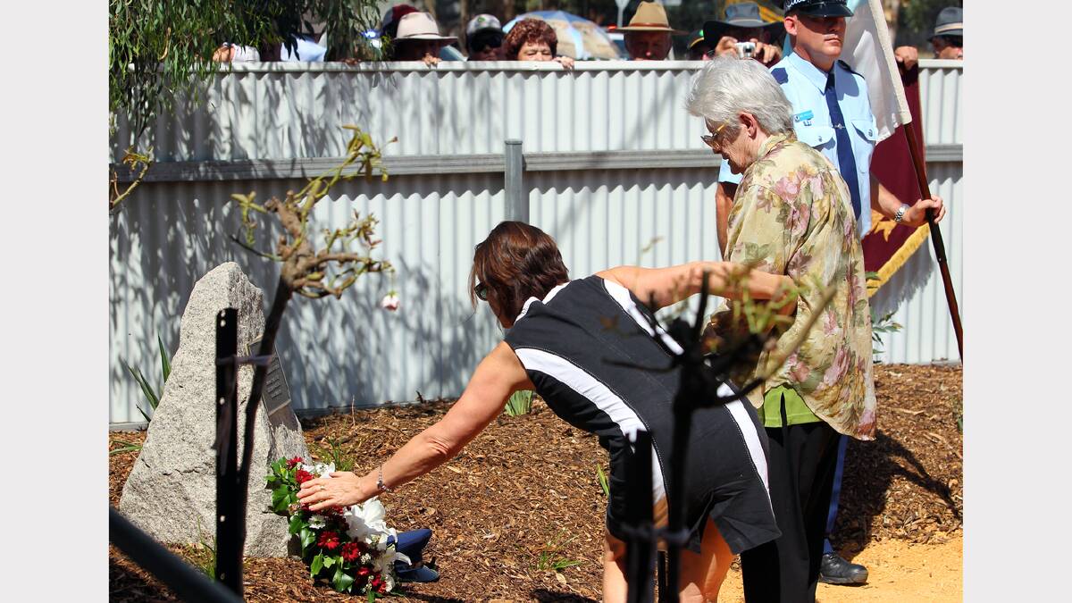 Kim Howe and her mother June Howe lay a wreath at the memorial of their father and husband Sgt Cyril Howe.