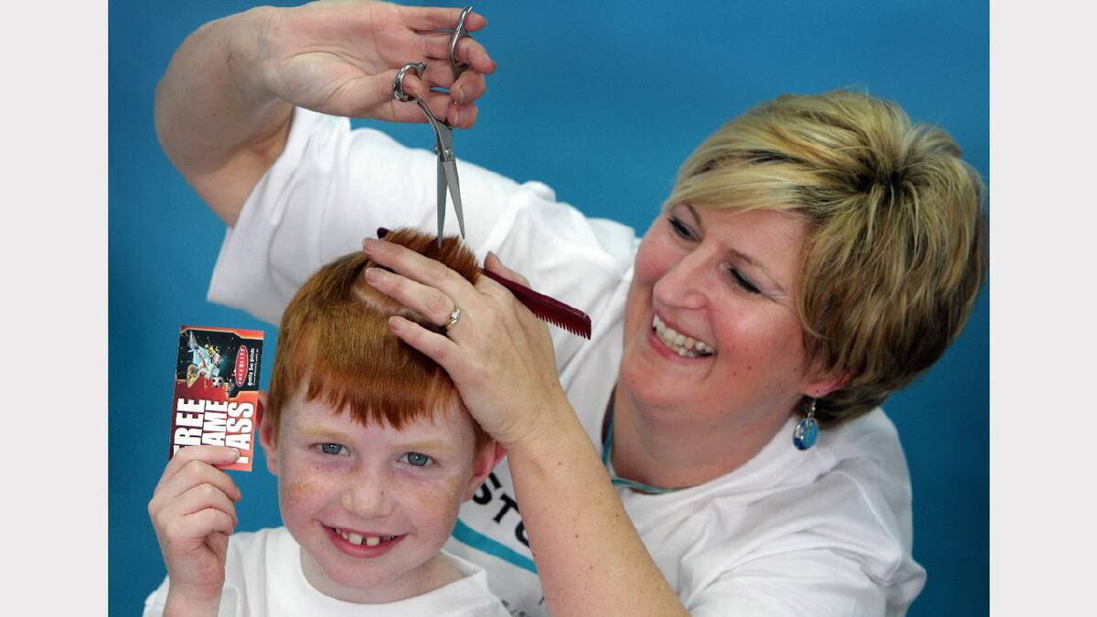 2010 - Jill Brown, owner of Studio 586, gets ready to cut the hair of Liam Elligate, 7, who is being treated for cancer.