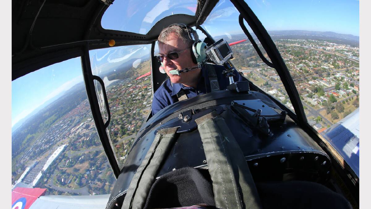 Pilot Stephen Death at the controls of a De Havilland Chipmunk aeroplane over Albury and Lake Hume. Picture: MATTHEW SMITHWICK