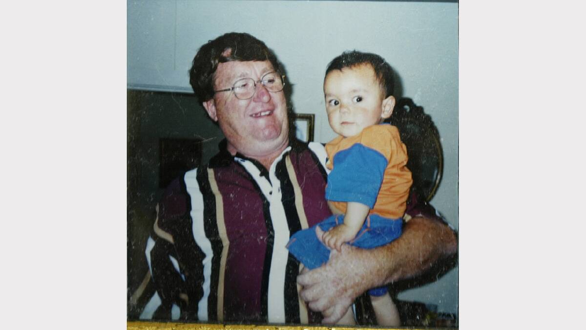 Kevin Ruffels holding his son Daniel Thomas as a baby.  
