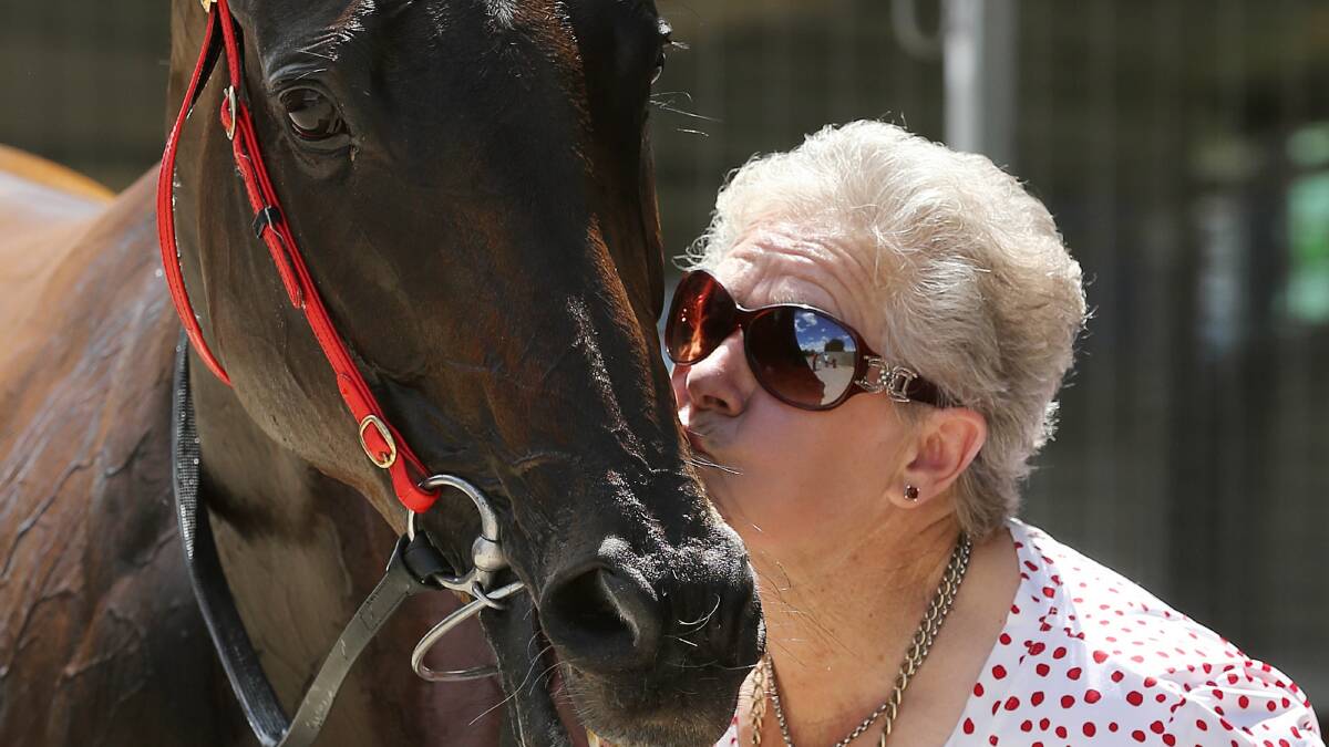 Liz Aalbers gives winner Dainty Sharnee a birthday kiss after yesterday’s victory. Pictures: JOHN RUSSELL