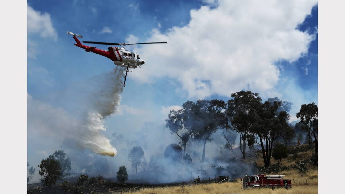 A waterbombing helicopter fights a bushfire at a property just east of Glenrowan. Picture: MATTHEW SMITHWICK