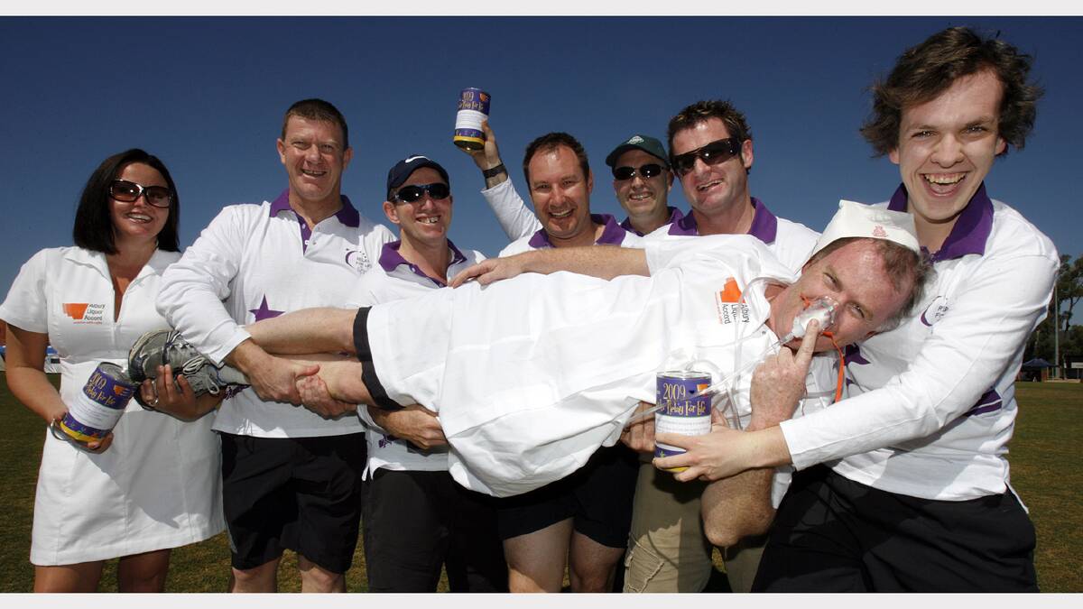 2009 -  Albury councellor Daryl Betteridge dressed as a nurse being held up by Albury Liquer Accord Members.