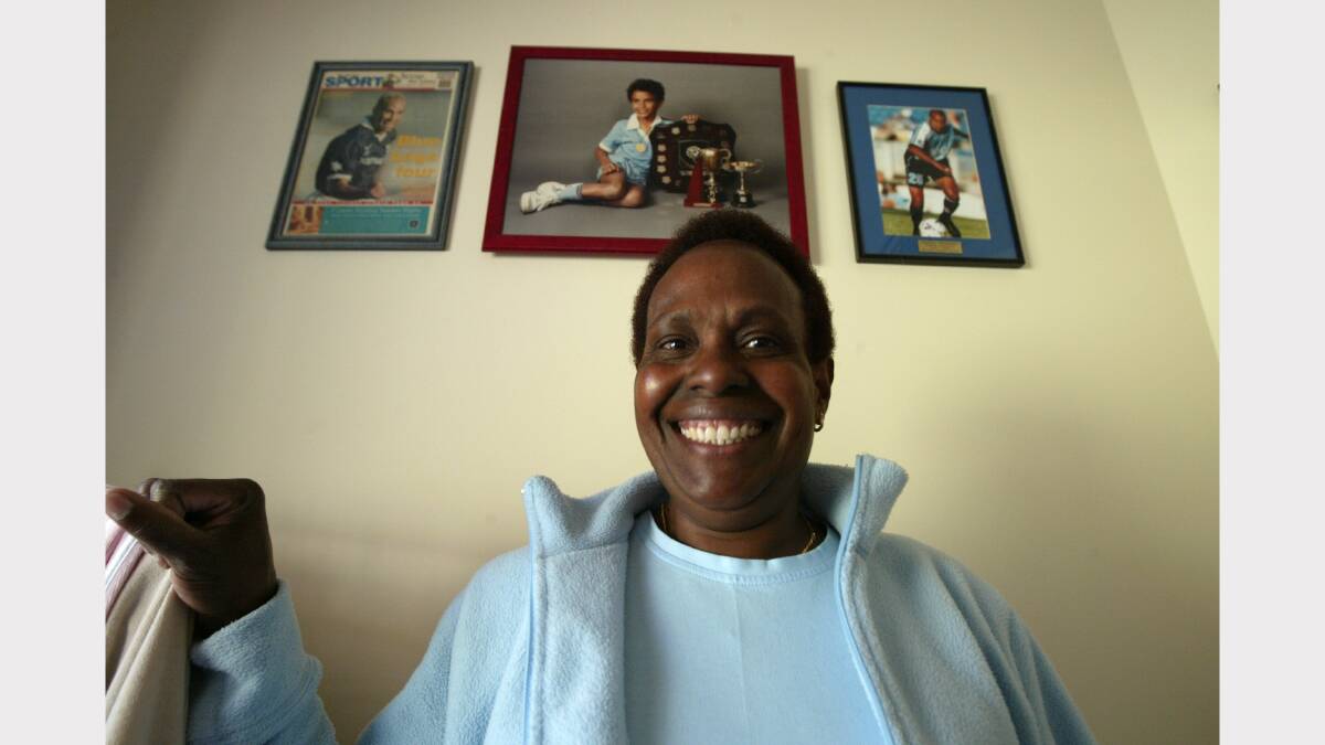 Archie Thompson's mother Esther Thompson with some of the pictures of him as he was growing up. 