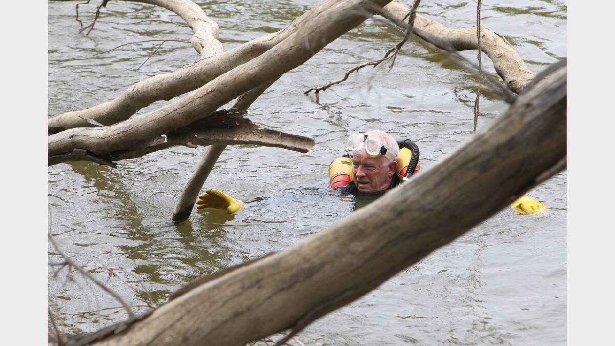 Corowa Rescue Squad diver Peter Wright checks around the snags in the Murray River.