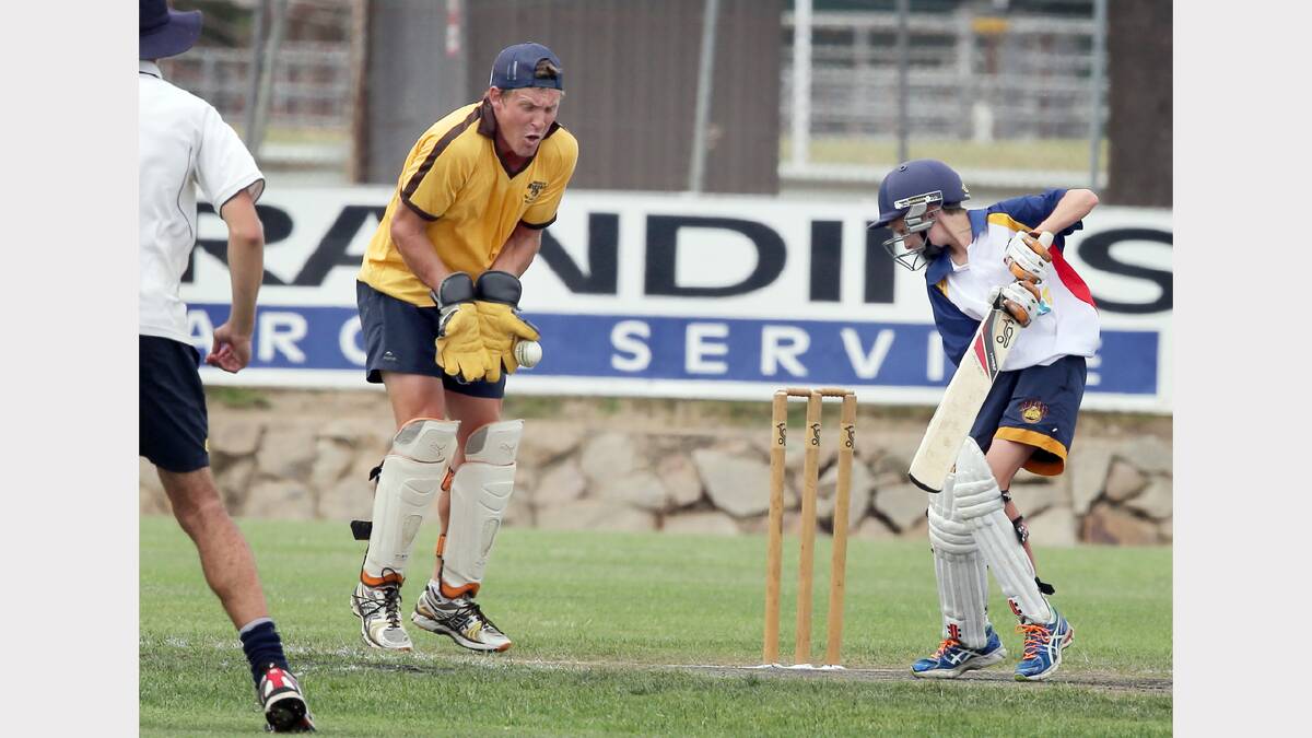 Wangaratta Rovers wicket keeper Luke Peters and United's batsman Matt Whitten, who normally plays in the U/12s.
