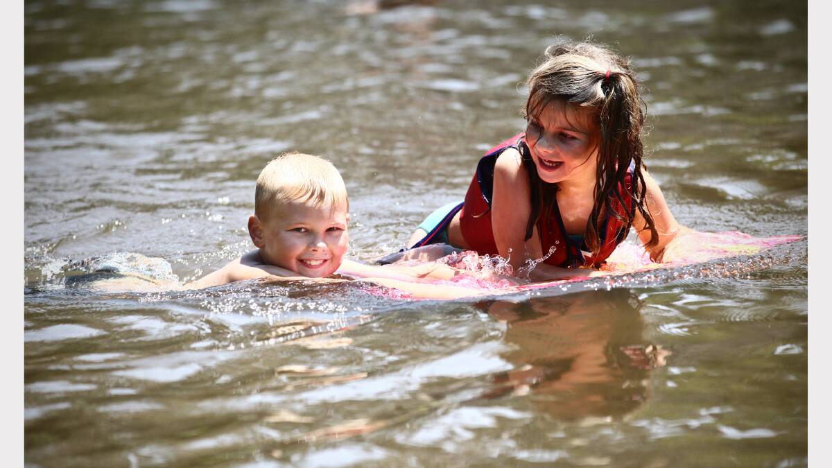  Brady Vauhkonen, 8, and Alicia Turner, 5, play in the Kiewa River. 
