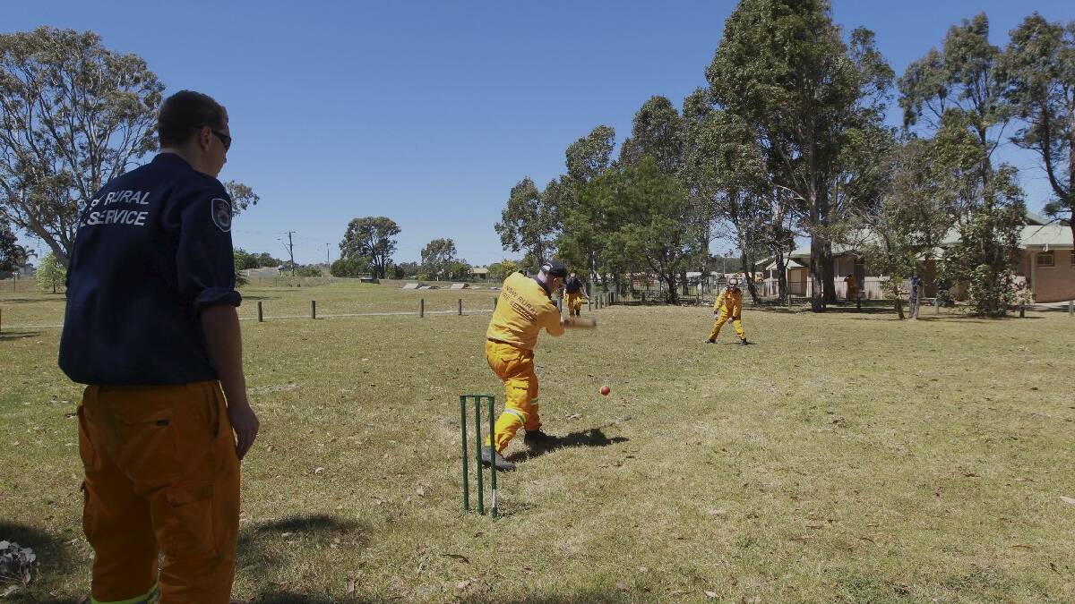 Firefighters at Bargo Oval in the Southern Highlands take a break with a game of cricket. Picture: Sahlan Hayes, SMH News.