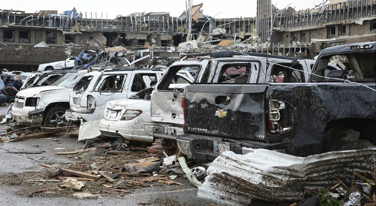 Damaged cars are seen in the parking lot of Moore Hospital after a tornado struck Moore, Oklahoma, May 20, 2013. Photo: REUTERS/Gene Blevins