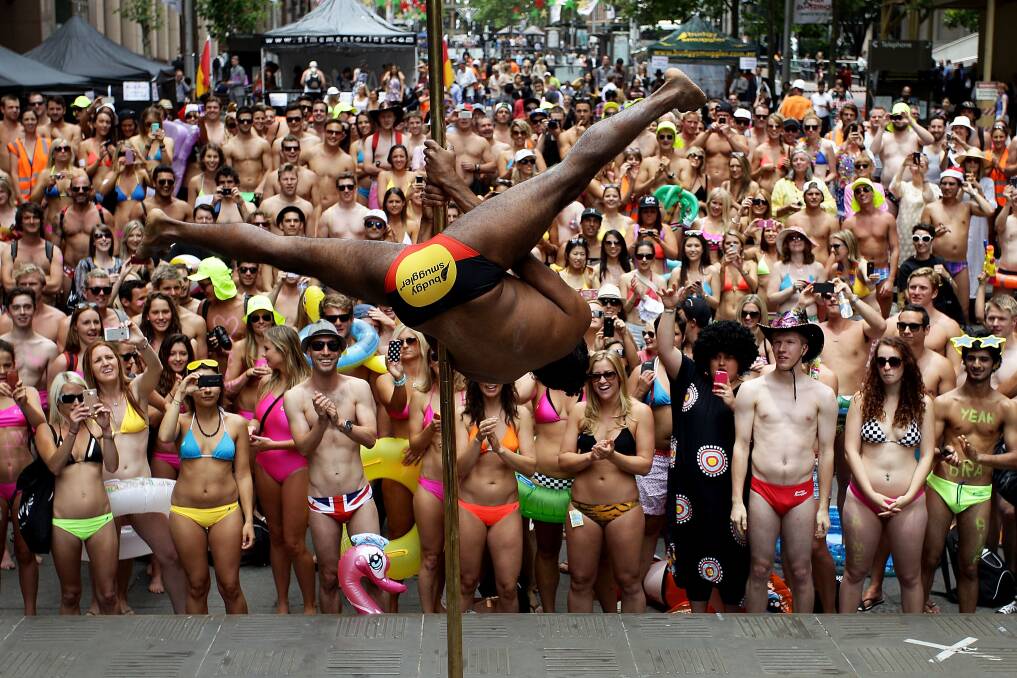 Sydneysiders take part in the 'AIME Strut the Streets' in an attempt to break the Guiness record for the world's largest swimwear parade in Sydney, Australia. Photo by Lisa Maree Williams/Getty Images