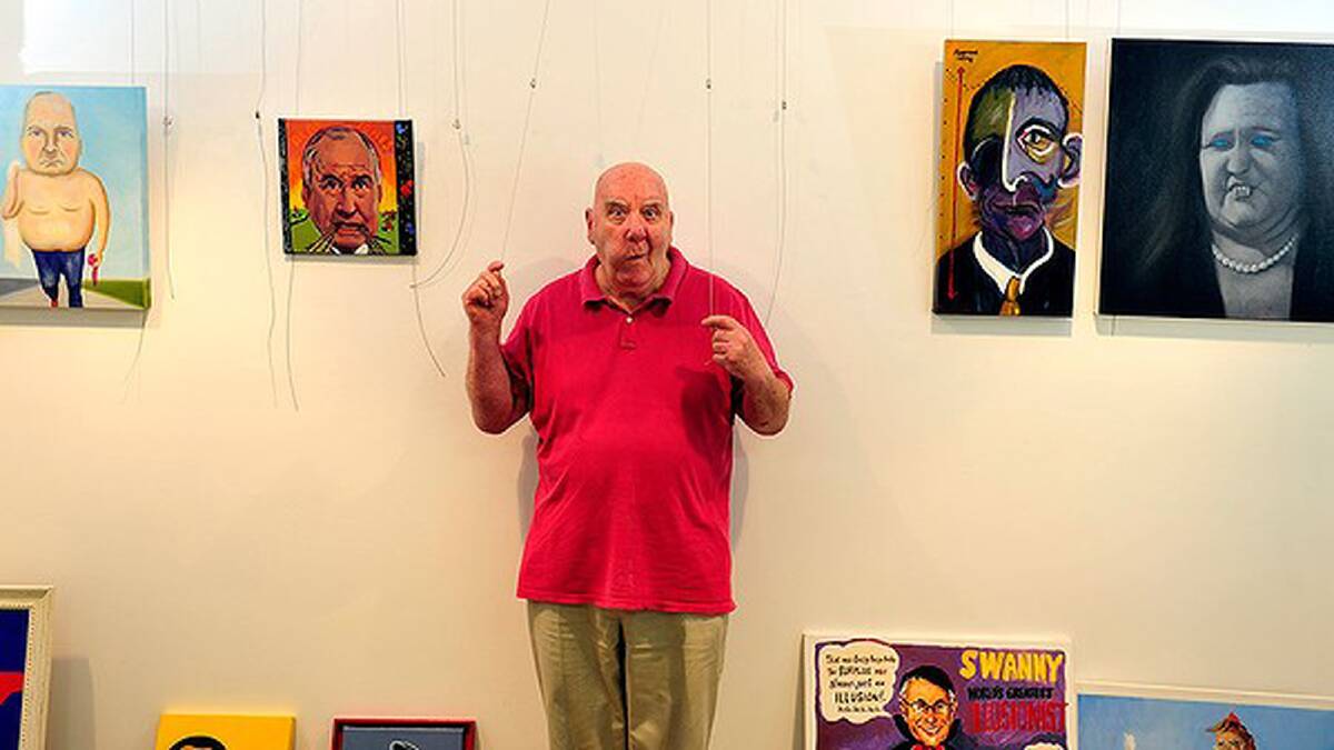 Peter Batey with some of the entries in the Bald Archy Prize 2013 on display at the Watson Arts Centre, Canberra. Photo: Melissa Adams.