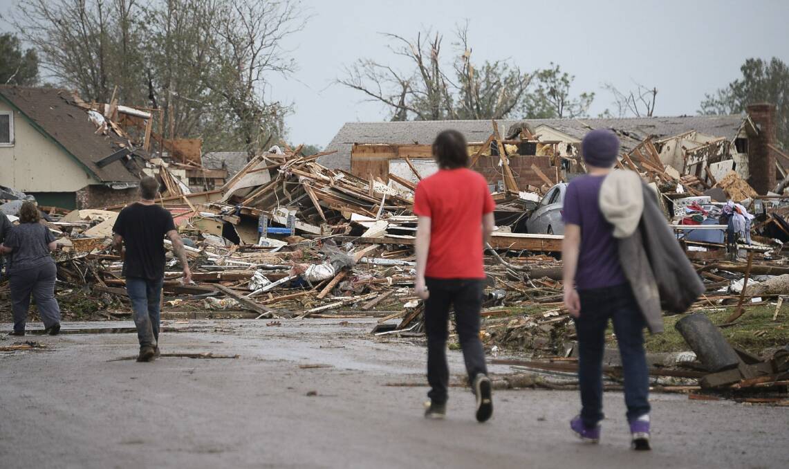 People walk through a neighbourhood after a tornado struck Moore, Oklahoma, May 20, 2013. Photo: REUTERS/Gene Blevins