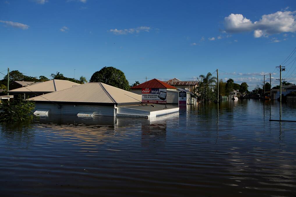 Houses and businesses are flooded as parts of southern Queensland experiences record flooding in the wake of Tropical Cyclone Oswald. Photo: Photo by Chris Hyde/Getty Images