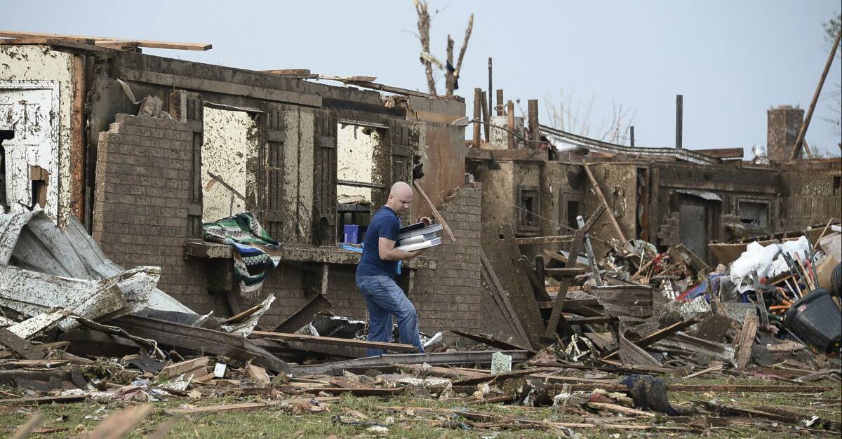 A man salvages his belongings after a tornado struck Moore, Oklahoma, May 20, 2013. Photo: REUTERS/Gene Blevins