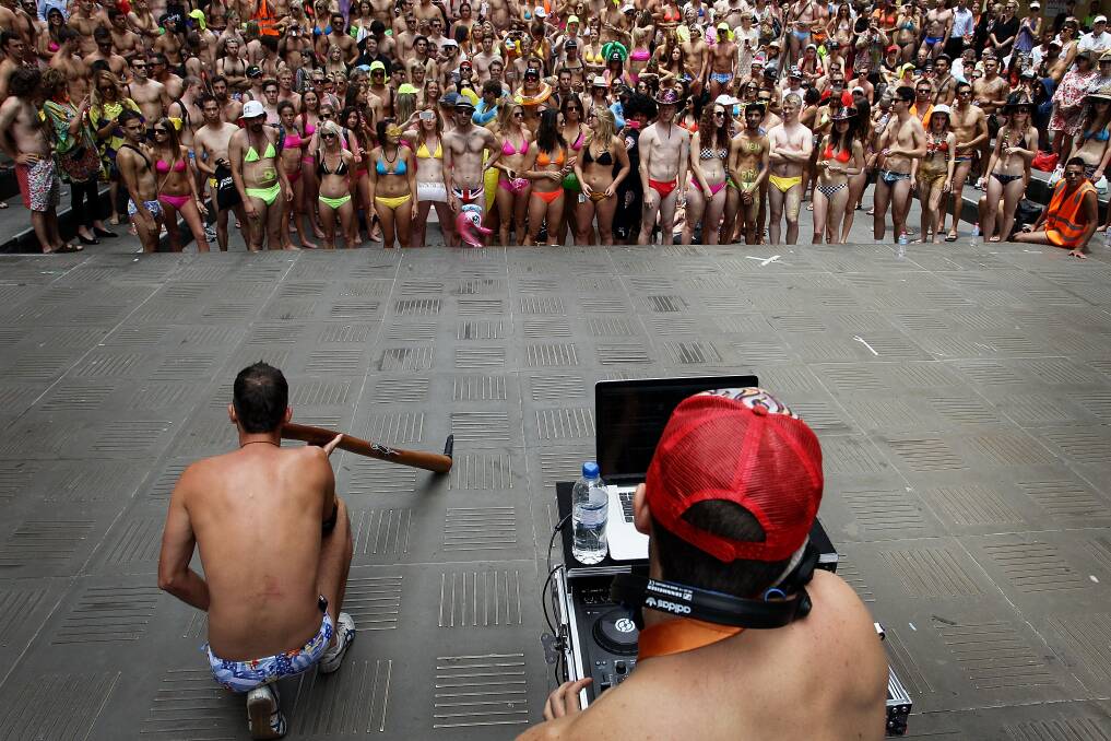 Sydneysiders take part in the 'AIME Strut the Streets' in an attempt to break the Guiness record for the world's largest swimwear parade in Sydney, Australia. Photo by Lisa Maree Williams/Getty Images
