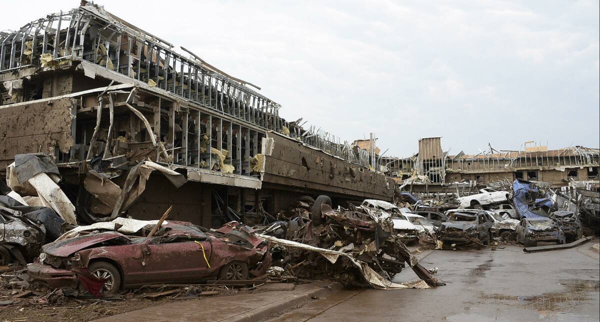 Damaged cars are seen in the parking lot of Moore Hospital after a tornado struck Moore, Oklahoma, May 20, 2013. Photo: REUTERS/Gene Blevins