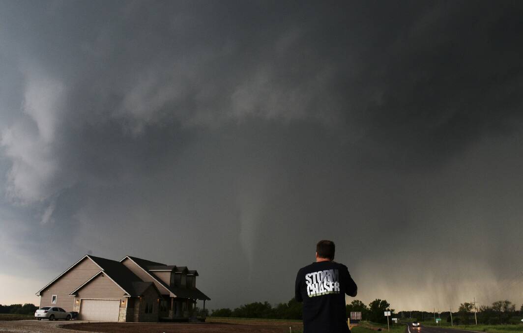 Storm chaser videographer and photographer Brad Mack records a tornado near a home in South Haven, in Kansas. Photo: REUTERS