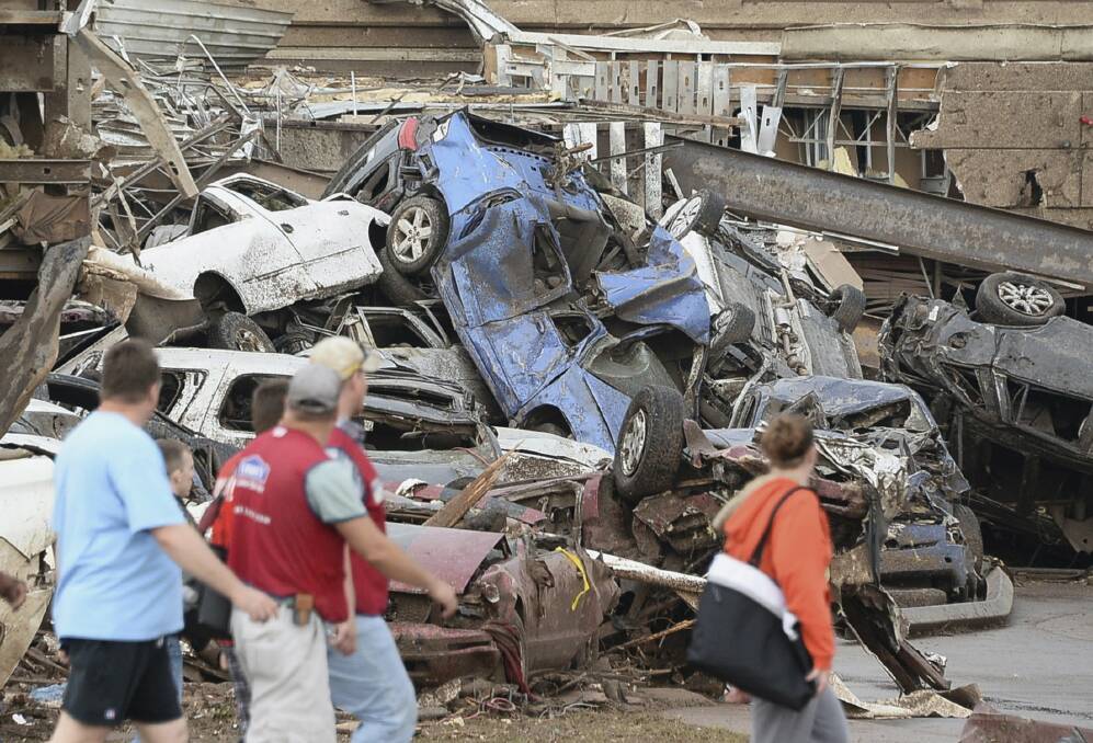 Damaged cars are seen in the parking lot of a Moore hospital after a tornado struck Moore, Oklahoma, May 20, 2013. Photo: REUTERS/Gene Blevins